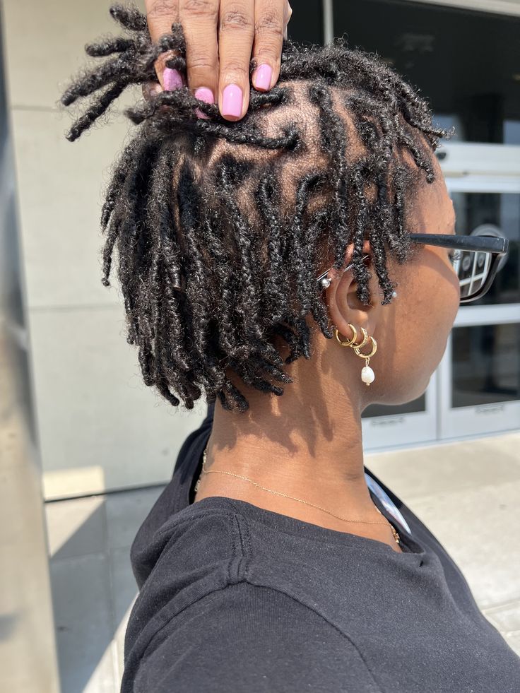 Black woman with freshly installed starter locs on natural 4C hair.