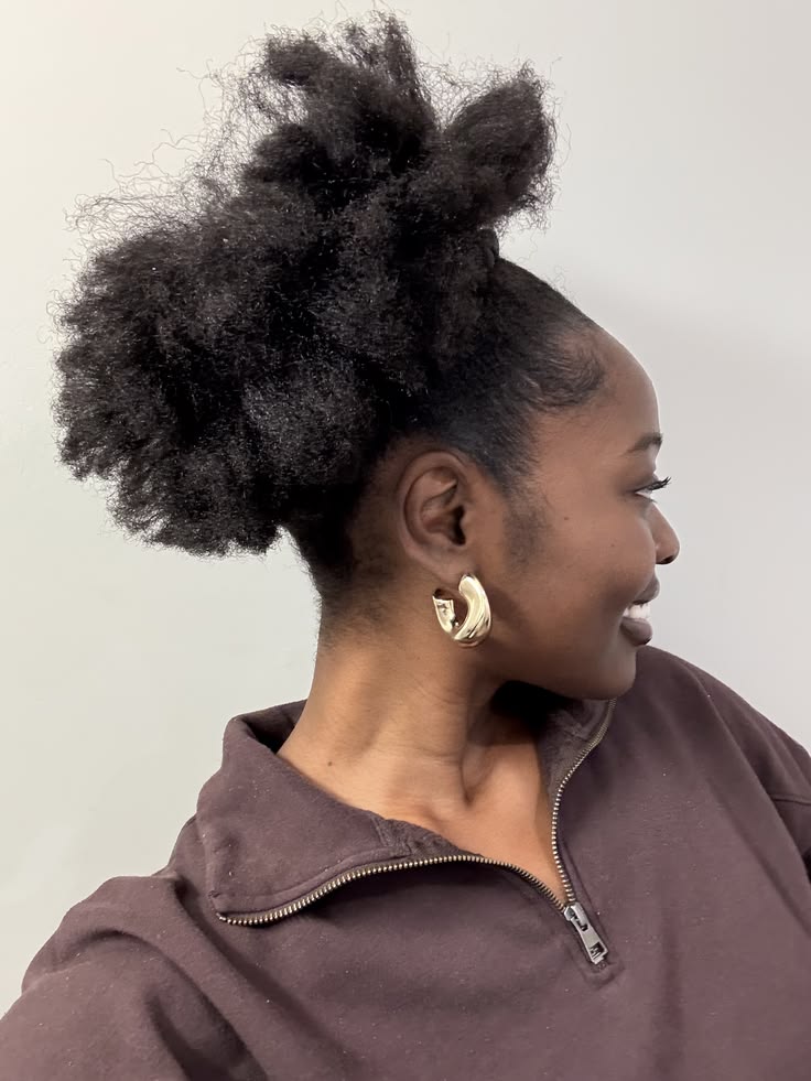 Stretched natural 4C hair styled into a puff