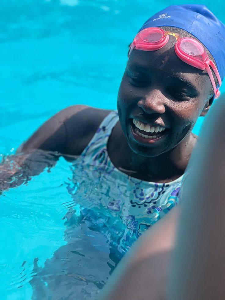 woman wearing a swimming cap while swimming 