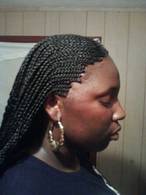 A woman on very tight hairstyle
