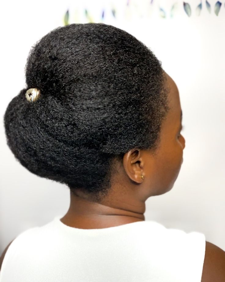 Tucked afro updo on natural 4C hair for a wedding
