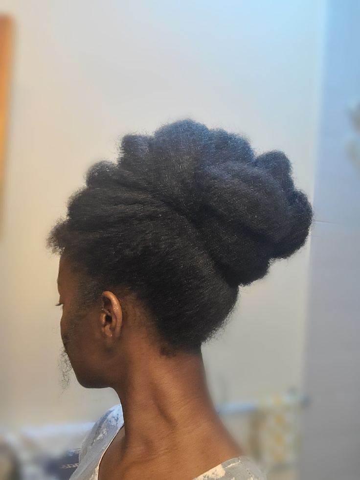 Natural 4C hair styled into a tucked afro updo
