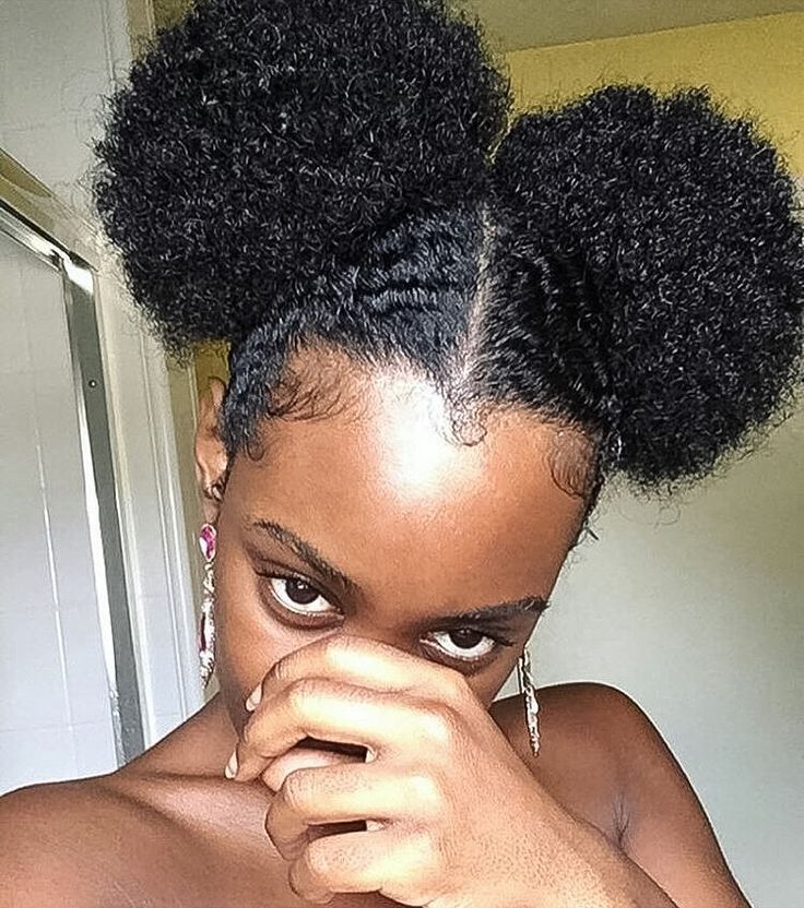 Natural 4C hair styled into cute two afro puffs