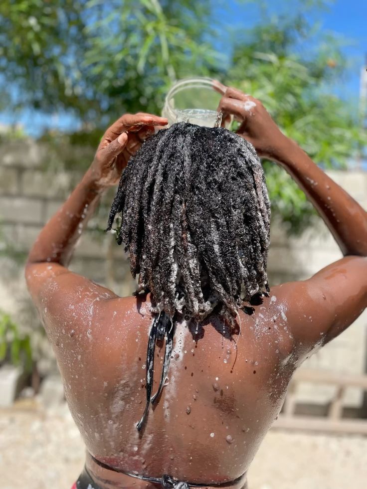 Woman washing natural hair after swimming