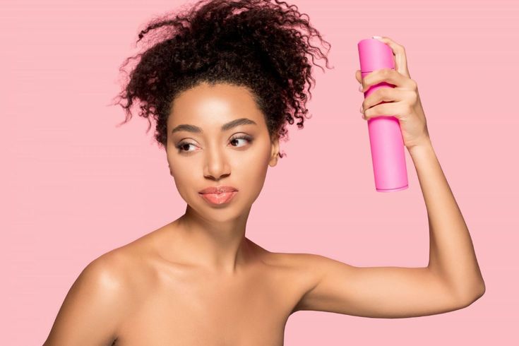 Applying water to natural 4C hair before moisturizing.