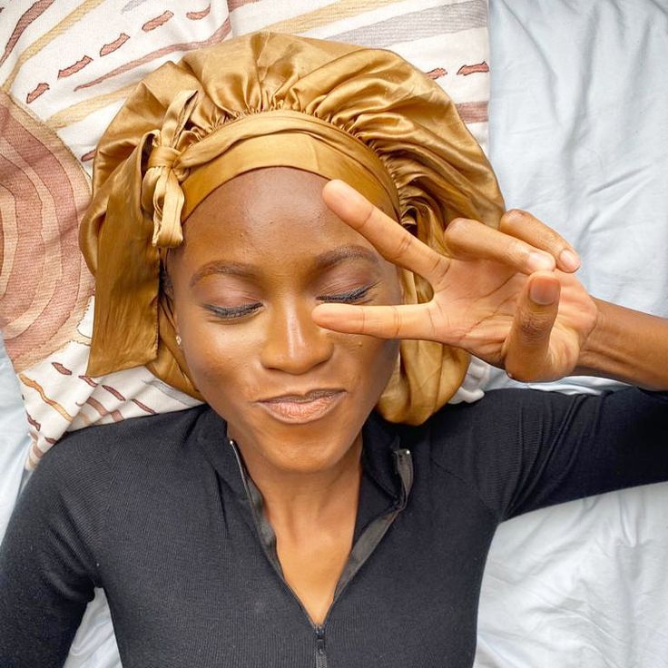 woman wearing satin bonnet to protect her locs