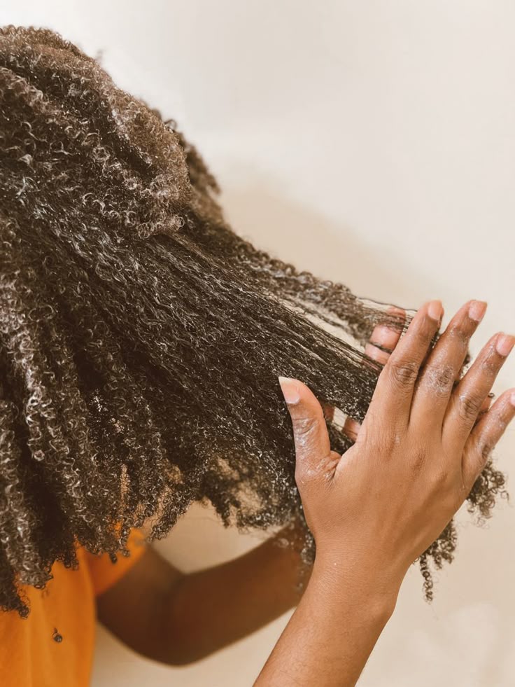 Woman caring for the ends of her natural 4C hair