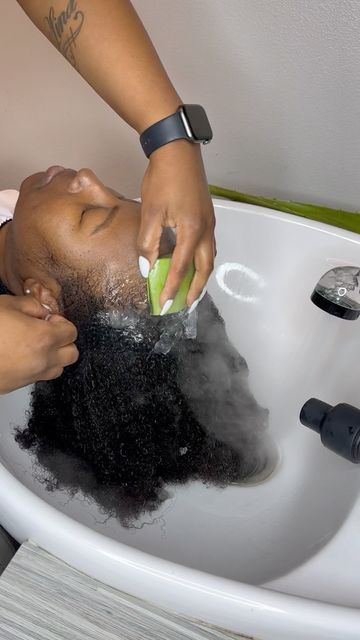 Natural hair being gently handled during a healthy hair-care routine.