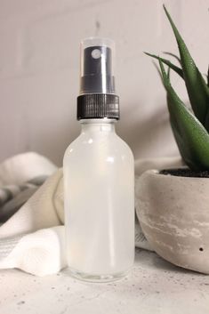 A small spray bottle filled with an aloe vera and water mixture.