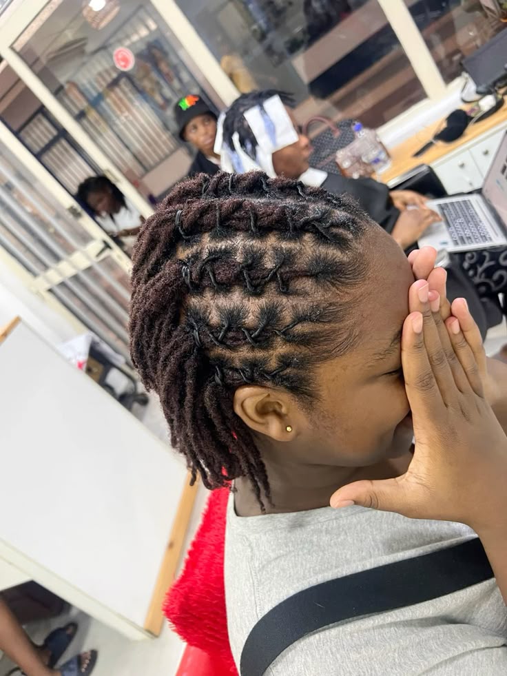 Longer starter locs arranged in a structured barrel-inspired style