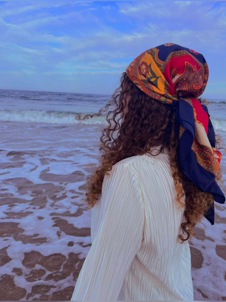 Woman wearing a scarf to protect natural hair at the beach
