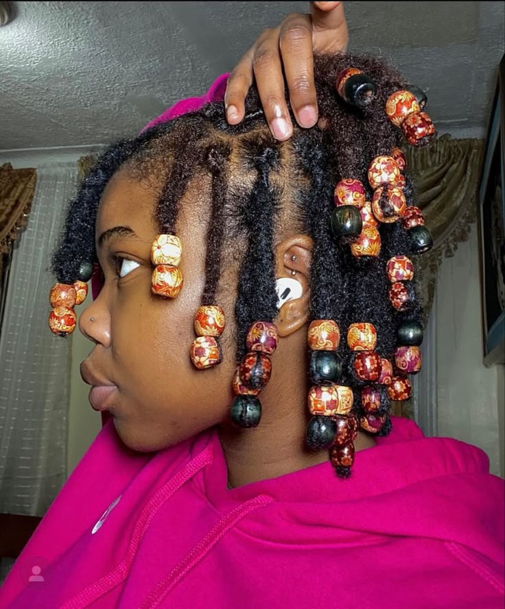Short starter loc decorated with lightweight hair beads