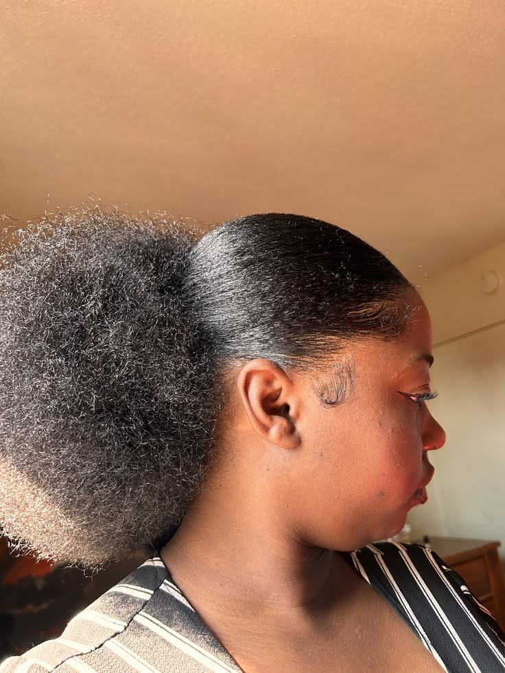 Natural 4C hair styled into a large puff after a blowout