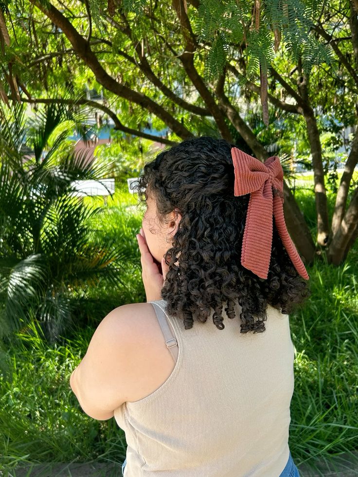 Alt Text: Natural twist-out finished with a decorative bow