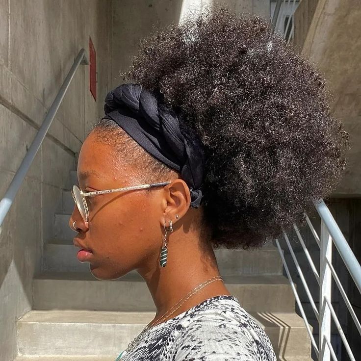 Braid-out natural 4C hair styled into a puff with a scarf