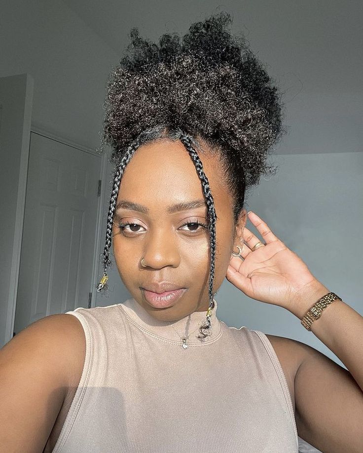 Natural 4C puff hairstyle with a braided bang