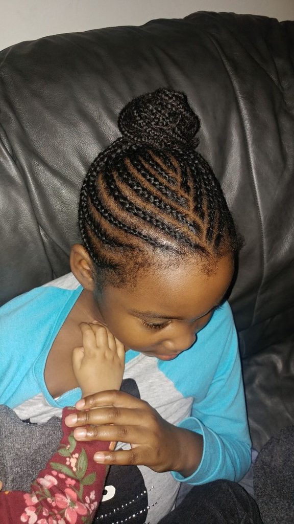 Active Black child wearing neat braided buns protective styles