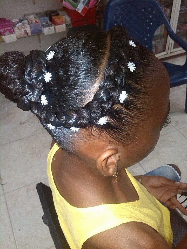 Young Black girl wearing a braided crown and low bun protective style