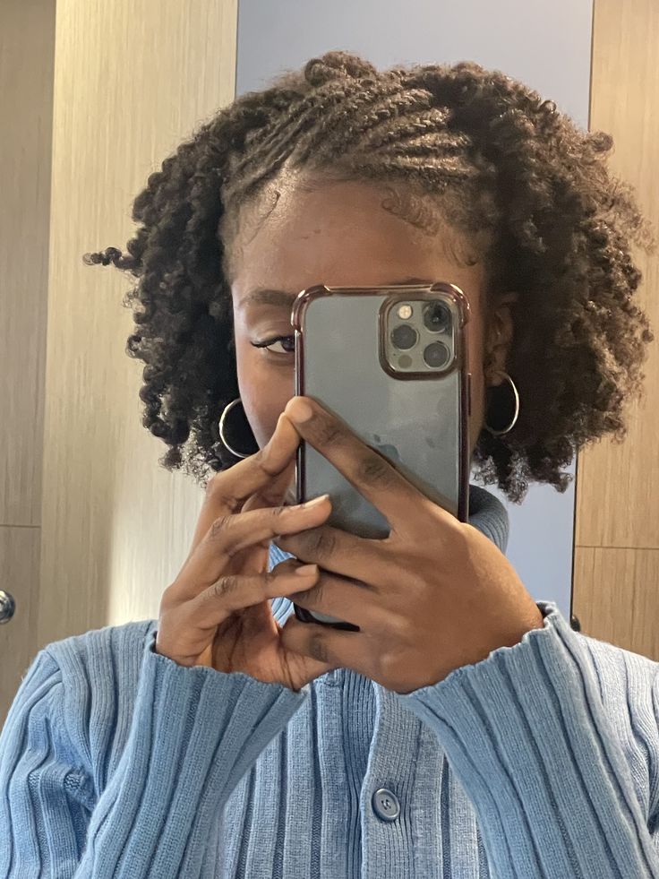 Woman wearing a braided half-up half-down natural hairstyle