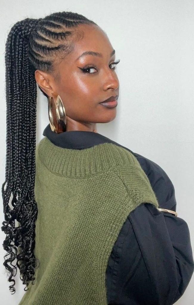 Woman with a high braided ponytail on 4C natural hair