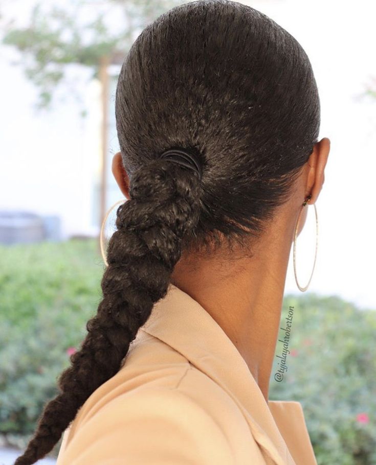Woman wearing an elegant low braided ponytail