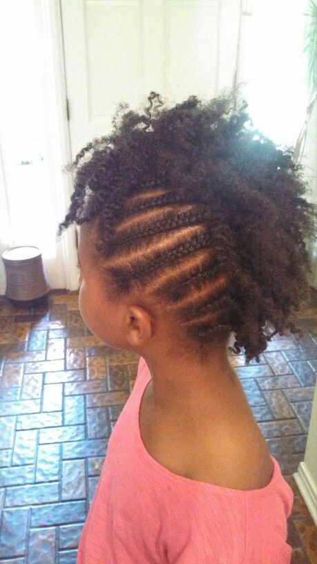 Black child wearing a playful braided mohawk natural protective styles