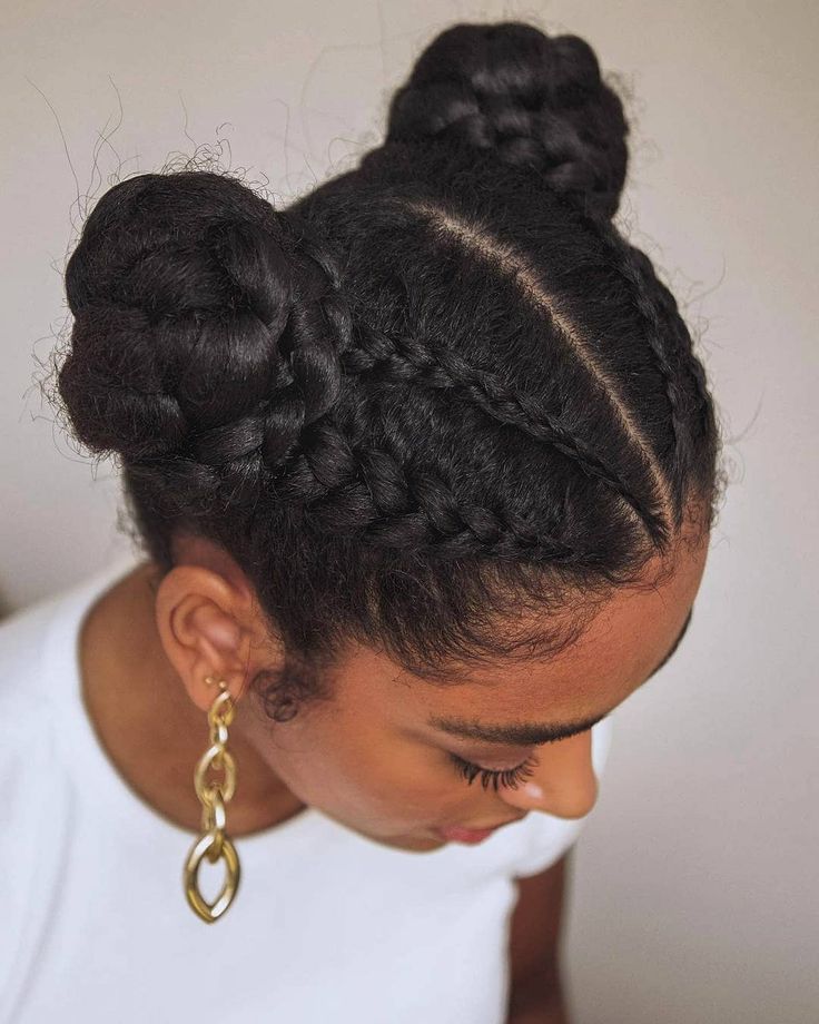 Woman wearing two braided space buns on natural hair