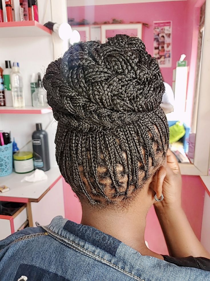 Woman wearing an elegant braided updo on natural 4C hair