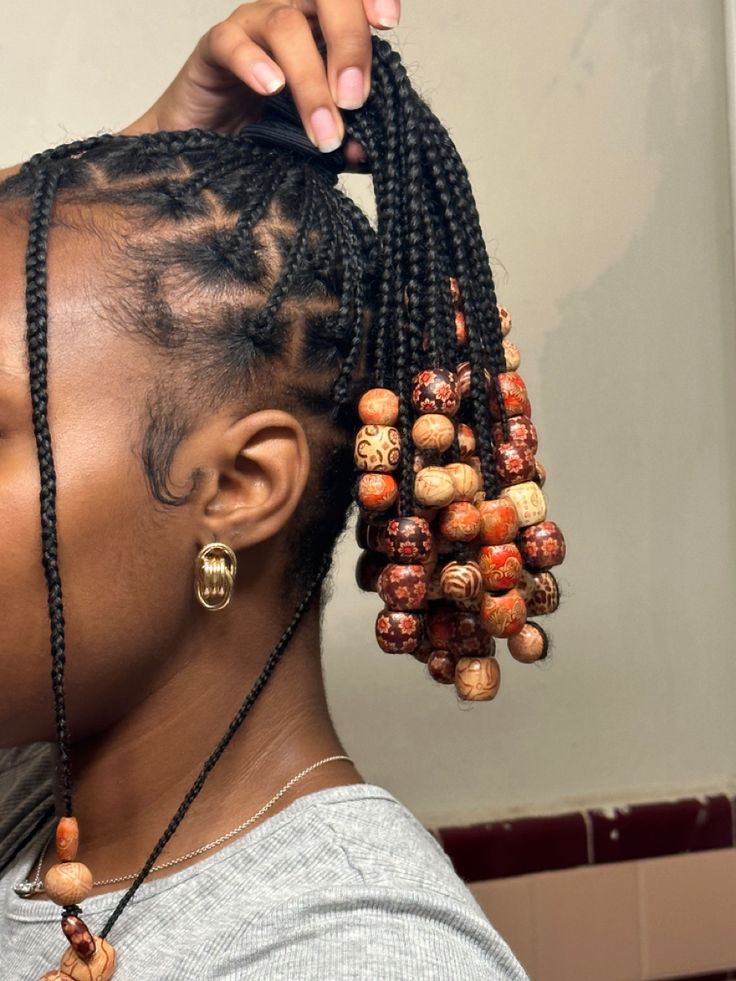 Woman wearing natural hair braids decorated with beads