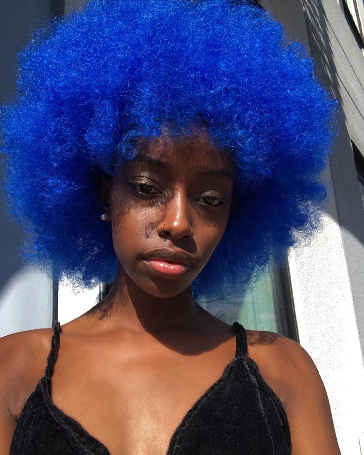 Black woman with bright blue natural hair color
