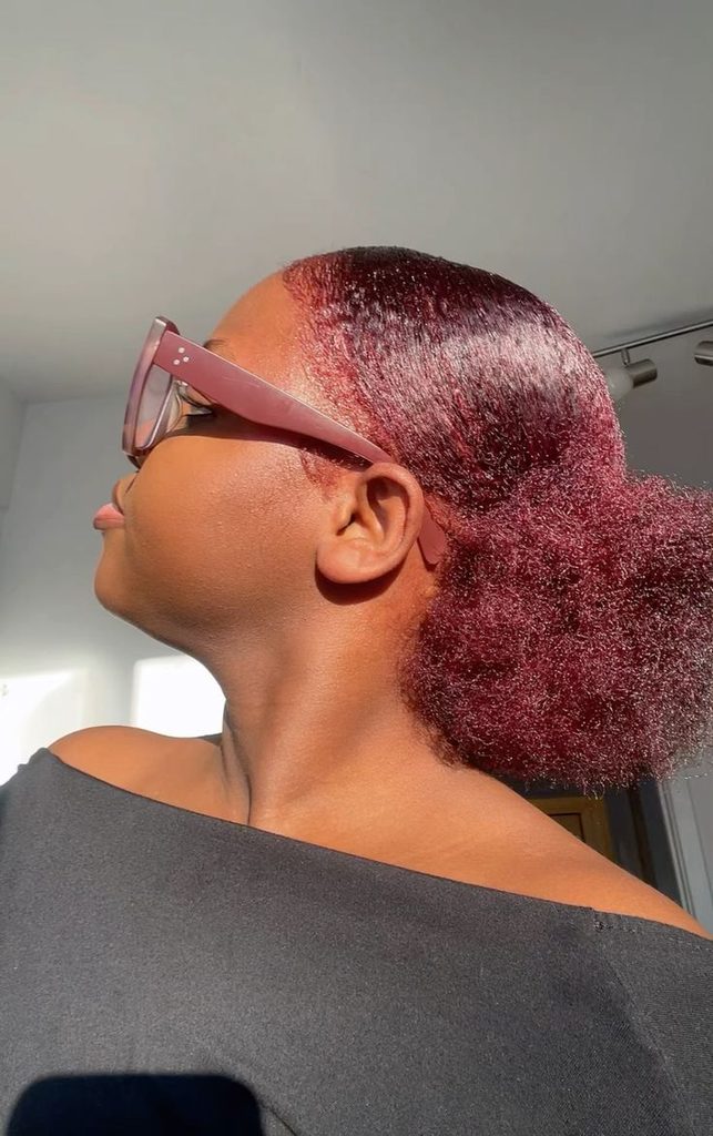 Black woman with deep burgundy natural hair for dark skin