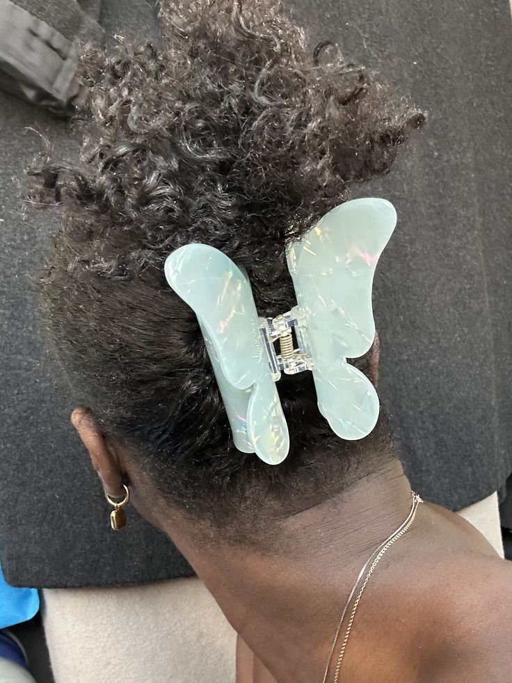 Woman wearing butterfly claw clips with natural hair