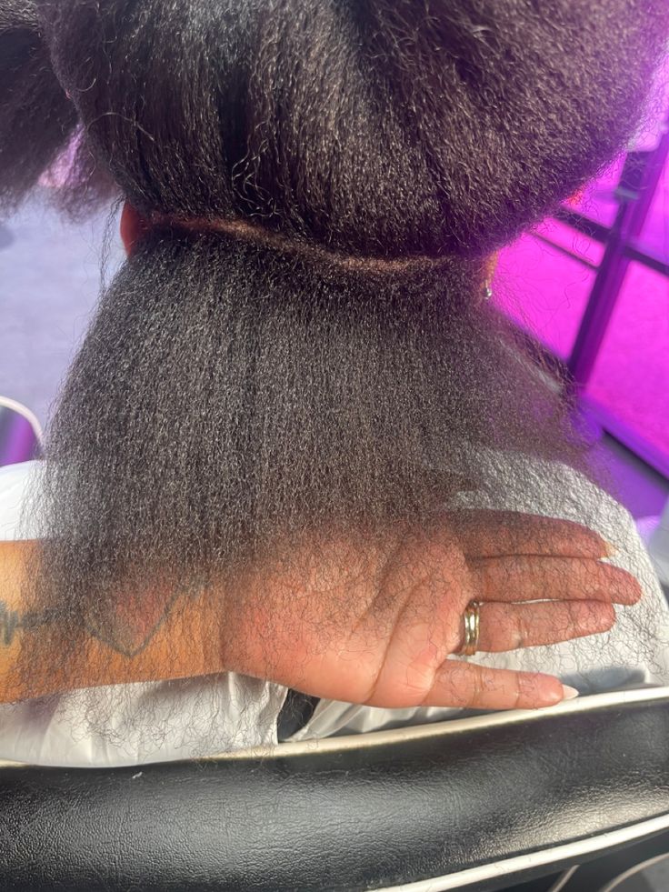 Close-up of natural hair ends being examined before a color treatment