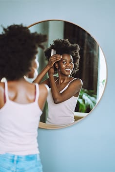 Woman examining her natural hair before a bleaching treatment