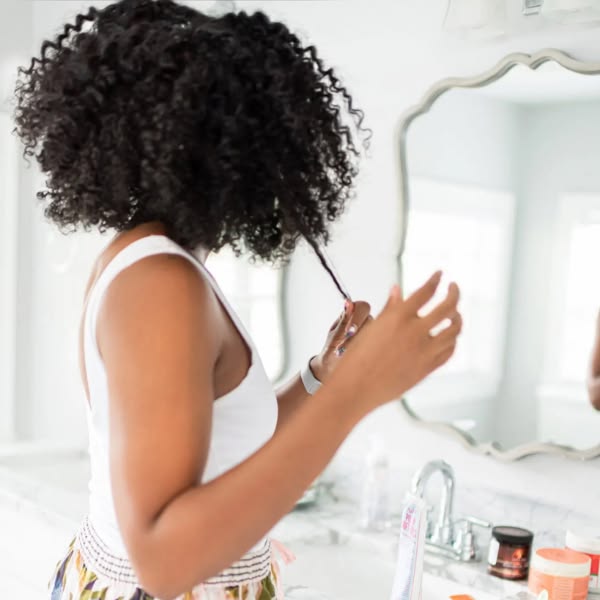 Woman examining the moisture and texture of her natural hair