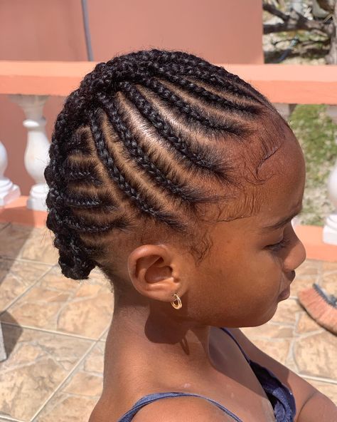 Child with neatly maintained 4C natural hair in a simple low manipulation style