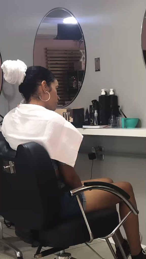Woman choosing a suitable hairstyle for transitioning natural hair