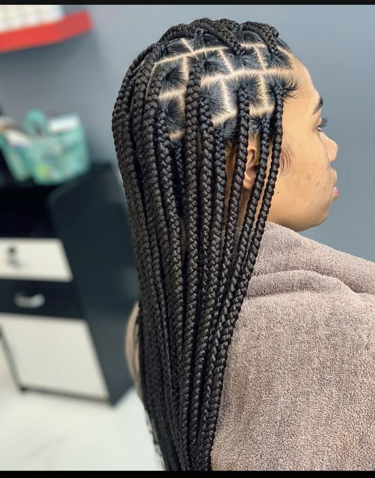 Woman with classic long box braids on natural 4C hair