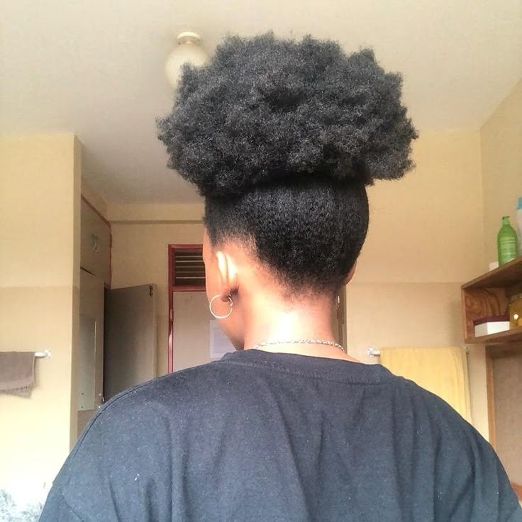 Woman wearing a classic high puff hairstyle on natural 4C hair