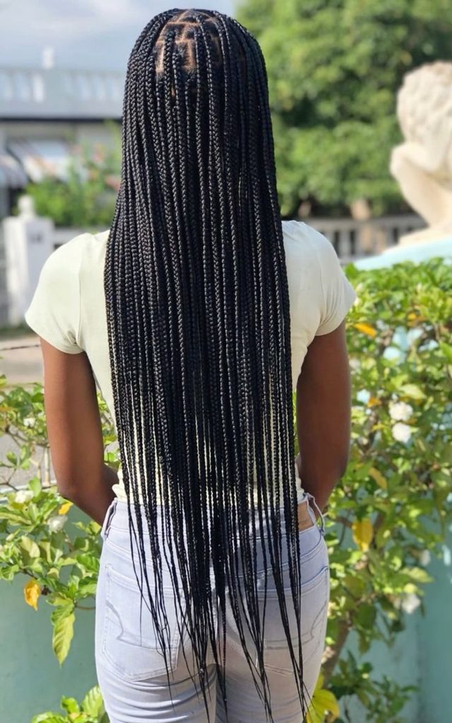 Woman wearing long classic braids on natural 4C hair
