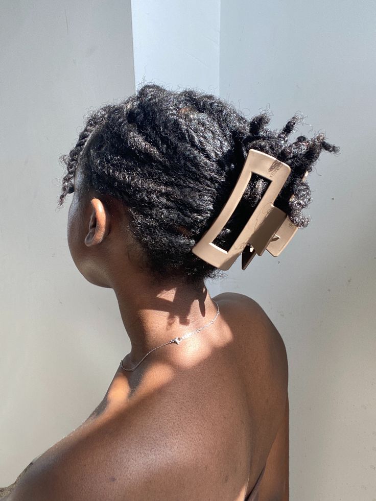 Woman using a claw clip to style natural hair