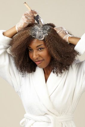 A woman trying to color her hair at home