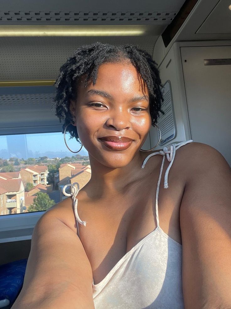 Beginner woman confidently wearing developing locs on 4C hair