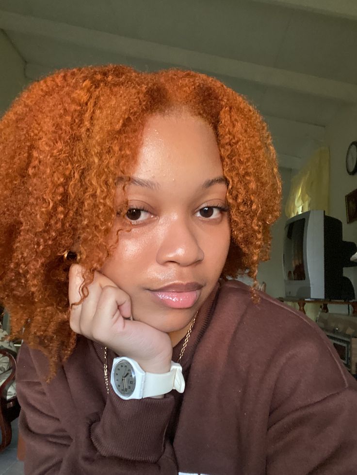 Black woman wearing copper natural hair color for dark skin