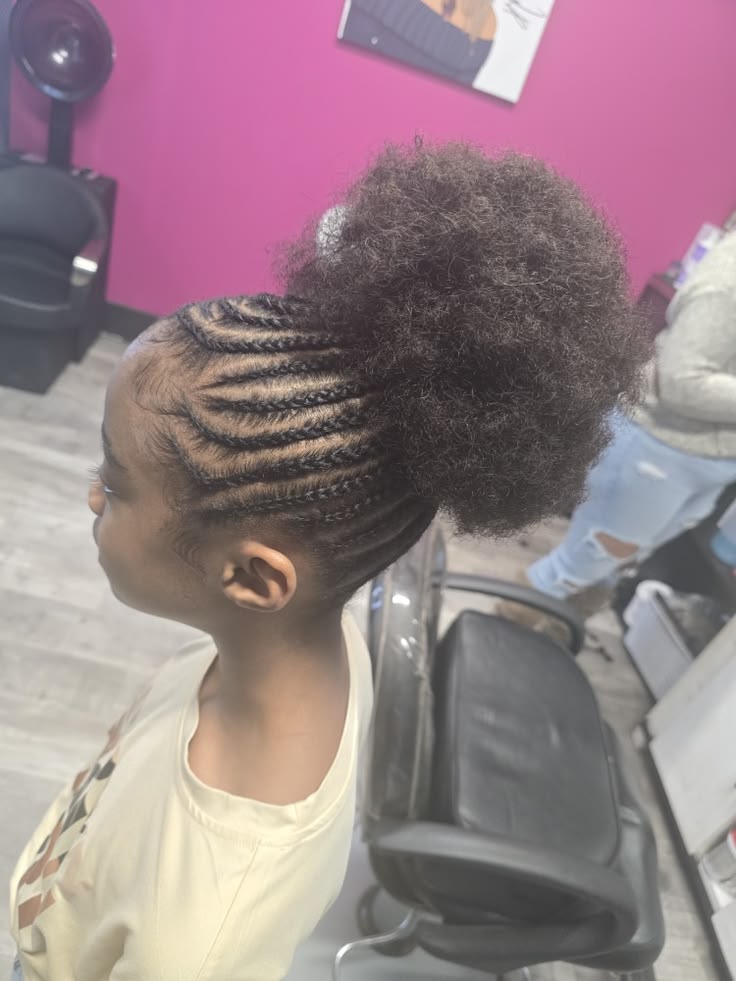 Black child wearing cornrows combined with a natural hair puff protective styles