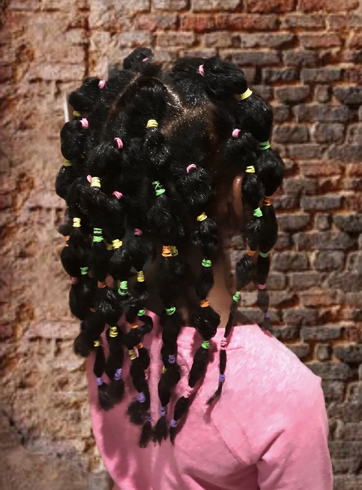Natural hairstyle created with decorative elastic bands
