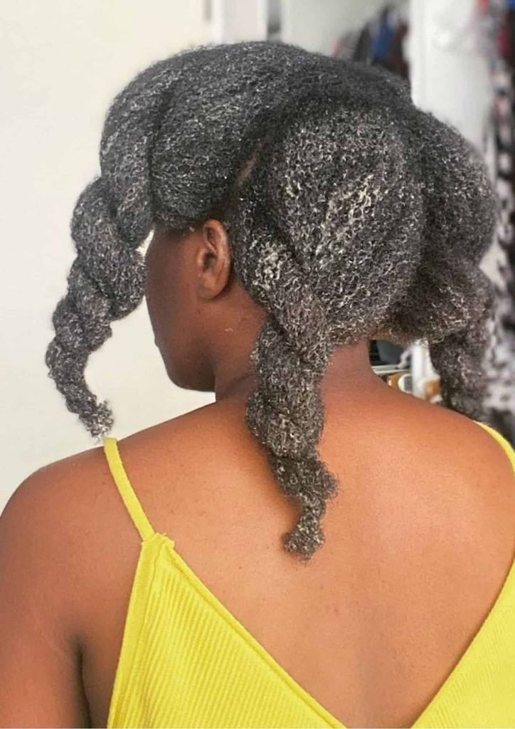 Woman deep conditioning natural 4C hair during winter