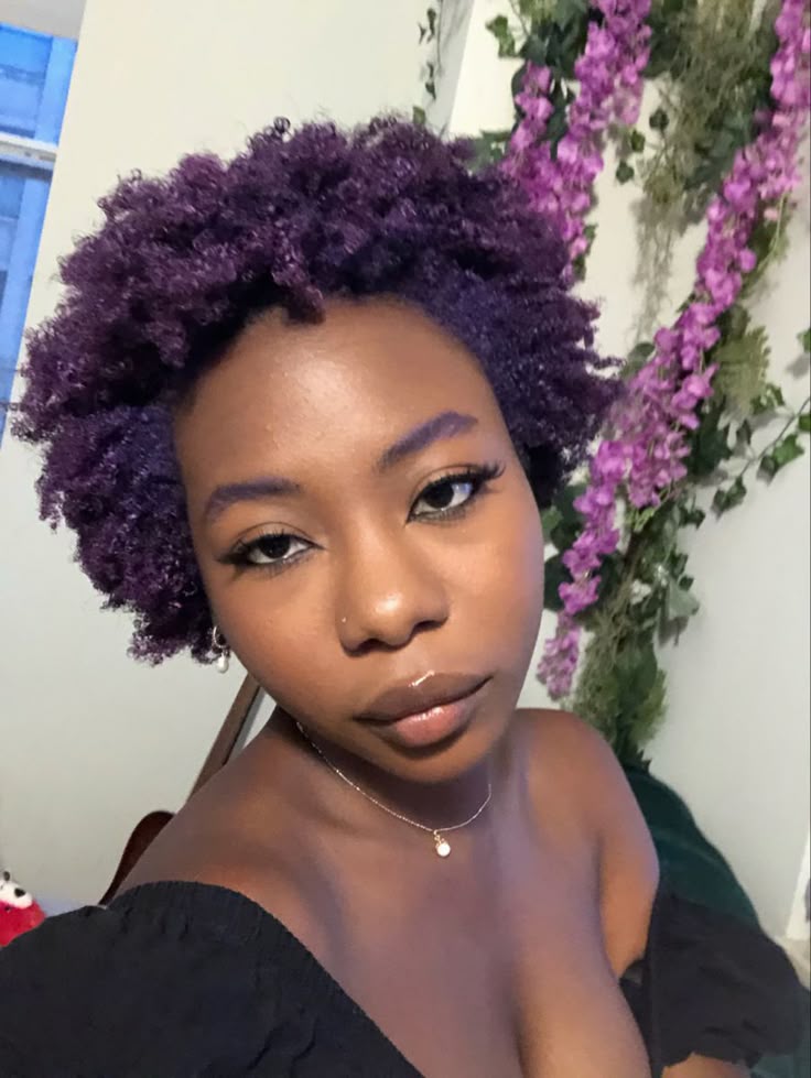 Black woman wearing deep purple natural hair color for dark skin