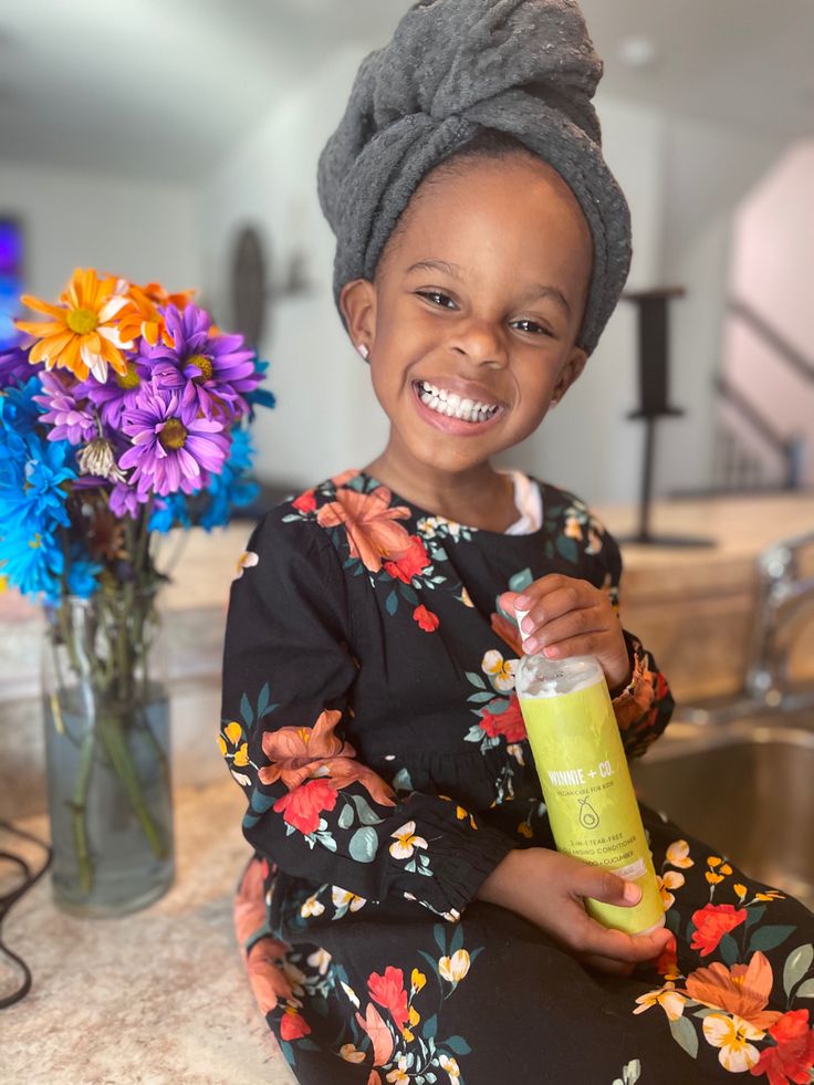 Child's 4C hair being gently dried with a soft towel as a part of wash day routine