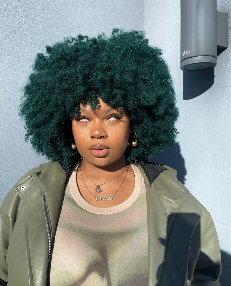 Black woman wearing deep emerald green natural hair